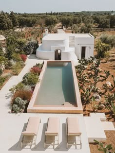 an aerial view of a house with a pool and lounge chairs