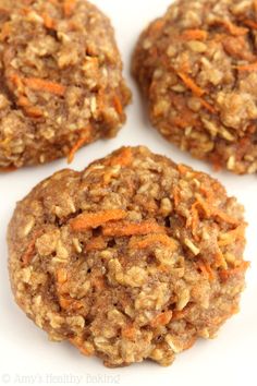 three cookies with carrots and oats on top