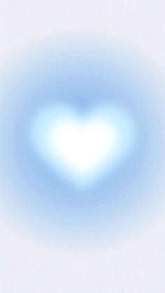 a heart shaped object in the sky with blue light coming from it's center