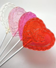 four lollipops shaped like hearts on top of each other