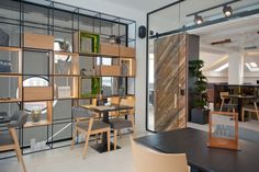 the interior of a restaurant with tables, chairs and shelves filled with bookshelves