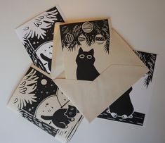 four black and white christmas cards on top of each other with an image of a cat