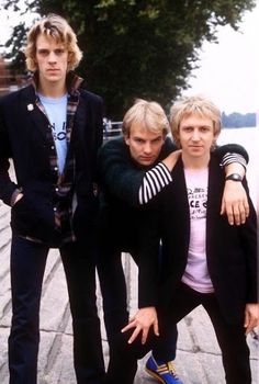 three young men standing next to each other