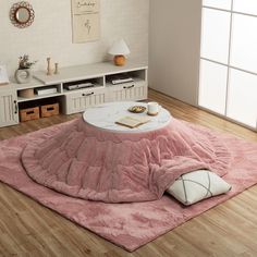 a living room with a pink rug on the floor