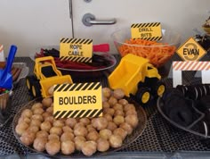 a table topped with lots of food and construction signs