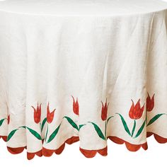 a white table cloth with red flowers on it