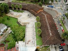 an aerial view of a building with cars parked in the parking lot next to it