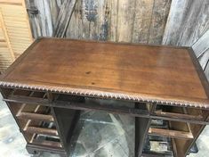 an old wooden desk with metal legs