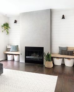 a living room filled with furniture and a fire place next to a wall mounted tv