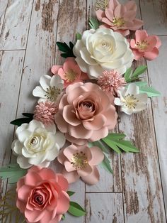 paper flowers are arranged on a wooden floor