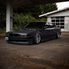 a black car parked in front of a garage