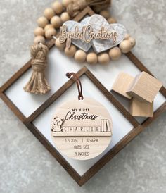 a personalized wooden ornament for a baby's first birthday with wood beads and tassels