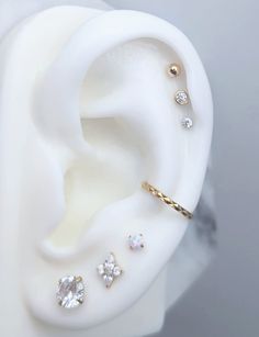 an ear is shown with three different types of piercings on it's side