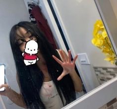 a woman with long black hair is taking a selfie in front of a mirror