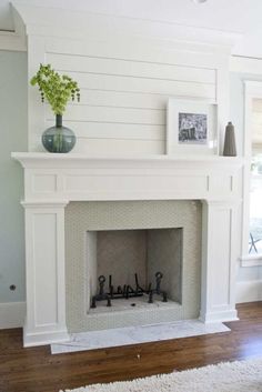 a living room with a fire place and white walls