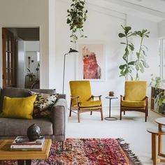 a living room filled with furniture and lots of plants