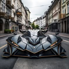 a black and gold batmobile is parked on the street in front of some buildings