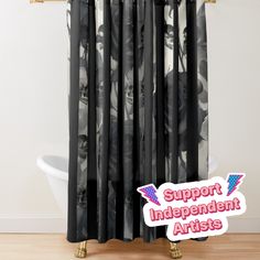 a black and white shower curtain with the words support independent artists on it in front of a bathtub