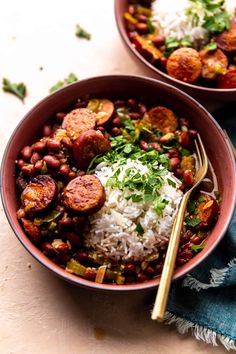 two bowls filled with beans and rice on top of a table