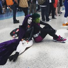 two people in costumes sitting on the ground