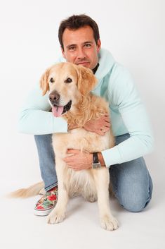 a man sitting on the floor with his dog