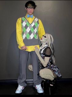 a man standing next to a creepy doll