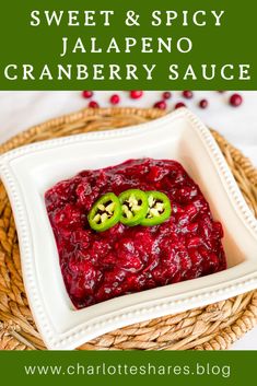 sweet and spicy jalapeno cranberry sauce in a square white bowl