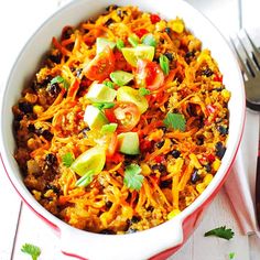 a white bowl filled with mexican food and garnished with cilantro peppers