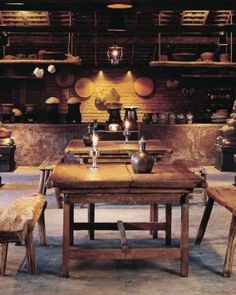 a wooden table surrounded by benches and baskets