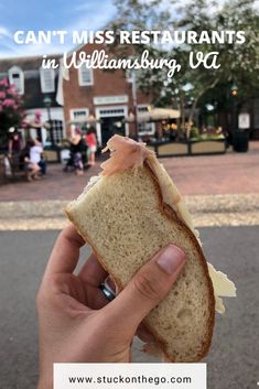 someone holding up a half eaten sandwich in front of a building with the words can't miss restaurants in williamsburg, ct