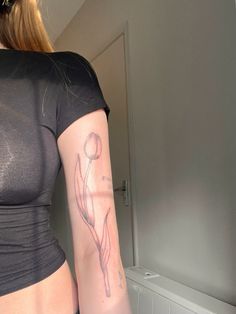 a woman with a tattoo on her arm