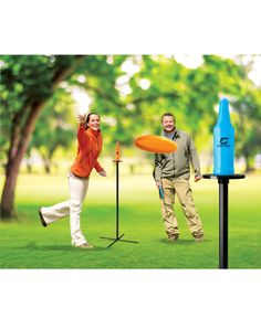 a man and woman playing frisbee golf in the park