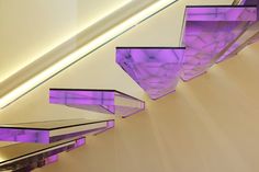 purple lights are shining down the ceiling in this modern design building's interior space