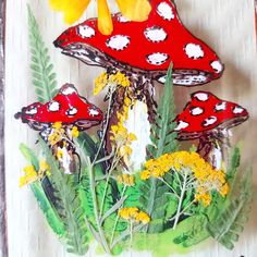 a painting of mushrooms and flowers on a piece of paper