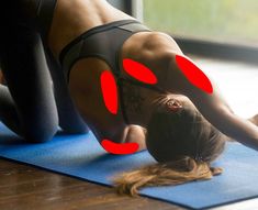 a woman is doing yoga on a mat with red circles in the shape of eyes