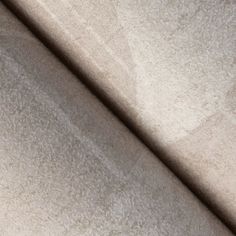 a close up view of a white fabric textured with light brown and beige colors