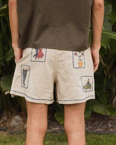 4.9 oz natural seed cotton from japandouble needle seam constructionelastic waistband with interior cotton drawcord binding on interior of waisttwill tape at side openingssingle pocket at backoriginal embroidered artwork this garment has undergone a wash and tint remove all shrinkage size & fit wide leg short inseam true to size Casual Embroidered Relaxed Fit Shorts, Beach Embroidered Cotton Shorts, Embroidered Cotton Beach Shorts, Playful Cotton Shorts, Sew Shorts, Weekend Chores, Box Shorts, Japanese Elements, Playful Cotton Bottoms With Built-in Shorts