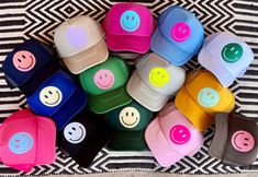 a pile of hats with smiley faces on them