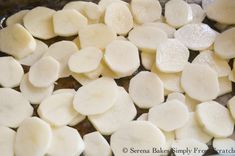 sliced potatoes are being cooked in a pan