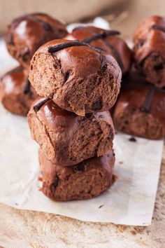 chocolate muffins stacked on top of each other with one broken in the middle