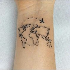 a small wrist tattoo with a world map and birds flying around the globe on it