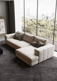 a modern living room with a large sectional sofa and floor to ceiling windows overlooking the city