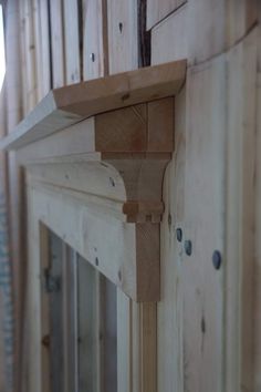 a close up of a wooden fireplace mantle with wood framing on the top and bottom