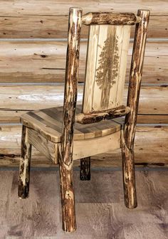 a chair made out of wood sitting on top of a floor next to a wooden wall