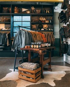 the inside of a clothing store with lots of items on display