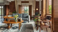 a living room filled with furniture and windows