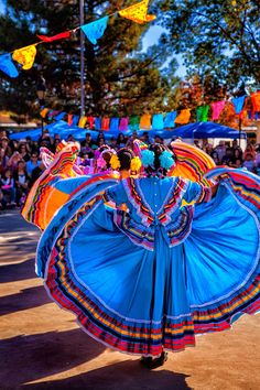 a group of people that are standing around with some kind of colorful dress on them