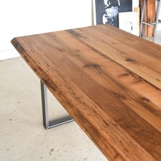 a wooden table with metal legs in a room