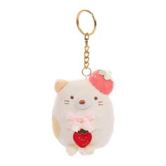 a stuffed animal keychain with a heart on it's chest and a strawberry on its head