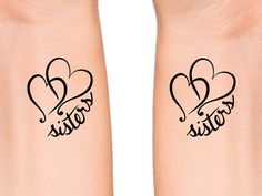 two tattoos that say sister and sister with hearts on their arms, the words sisters written in cursive writing